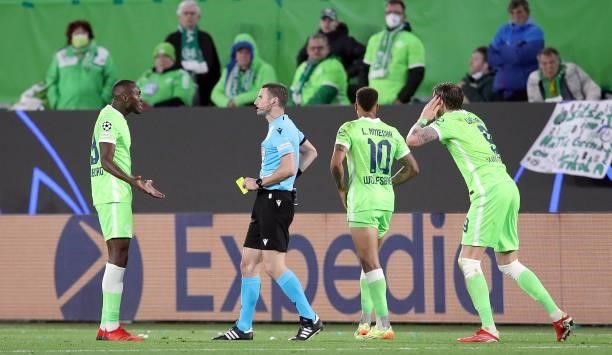 Wolfsburg's Dutch forward Wout Weghorst and Wolfsburg's German forward Lukas Nmecha react as Wolfsburg's French midfielder Josuha Guilavogui receives...