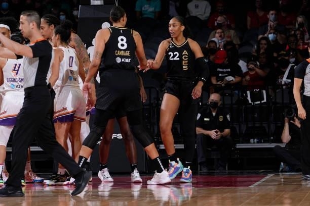 Ja Wilson high fives Liz Cambage of the Las Vegas Aces during the game against the Phoenix Mercury during Game Two of the 2021 WNBA Semifinals on...