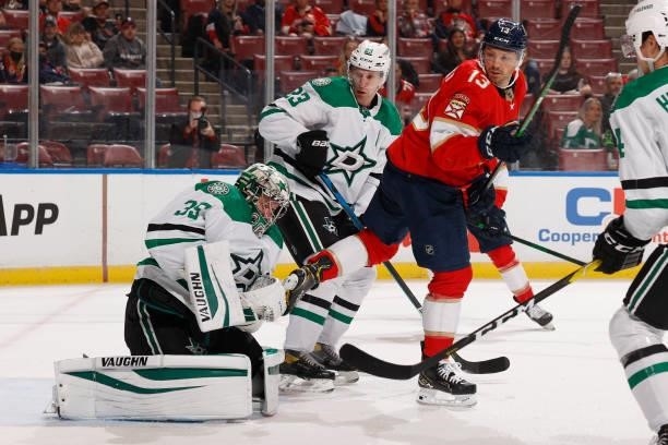 Sam Reinhart of the Florida Panthers looks back as Goaltender Anton Khudobin of the Dallas Stars stops a shot during first period action during a...