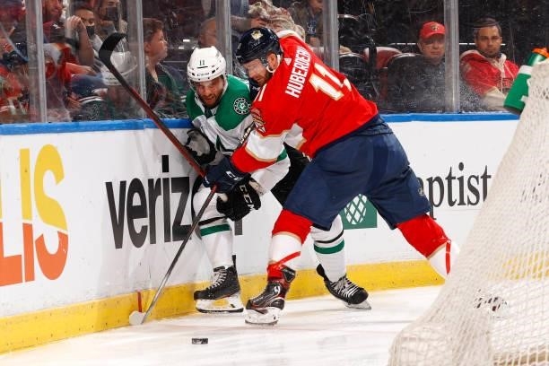 Luke Glendening of the Dallas Stars and Jonathan Huberdeau of the Florida Panthers battle for control of the puck during a preseason game at the FLA...