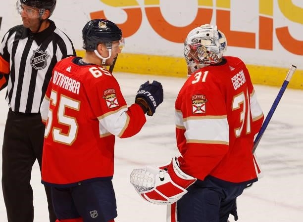 Goaltender Christopher Gibson is congratulated by Markus Nutivaara of the Florida Panthers after the game against the Dallas Stars during a preseason...