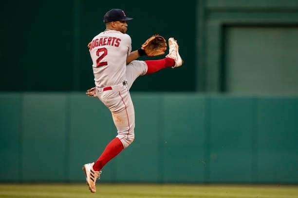 Xander Bogaerts of the Boston Red Sox leaps as he throws during the seventh inning of a game against the Washington Nationals on October 2, 2021 at...