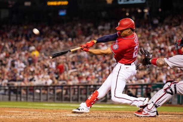 Juan Soto of the Washington Nationals hits a game tying sacrifice fly during the eighth inning of a game against the Boston Red Sox on October 2,...