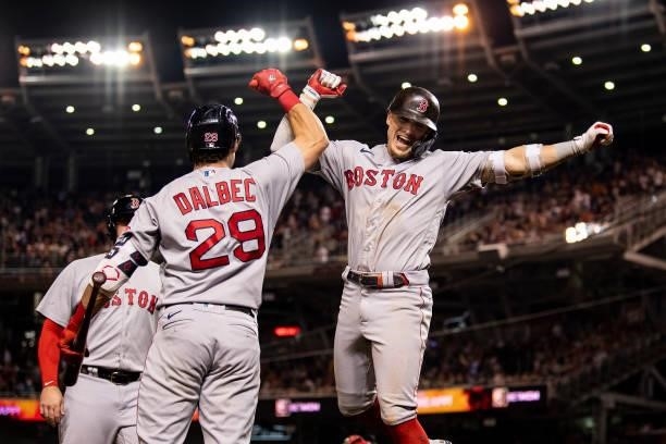 Enrique Hernandez of the Boston Red Sox reacts with Bobby Dalbec after hitting a two-run home run during the ninth inning of a game against the...