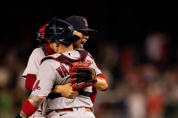 Hansel Robles and Christian Vazquez of the Boston Red Sox celebrate a victory against the Washington Nationals on October 2, 2021 at Nationals Park...