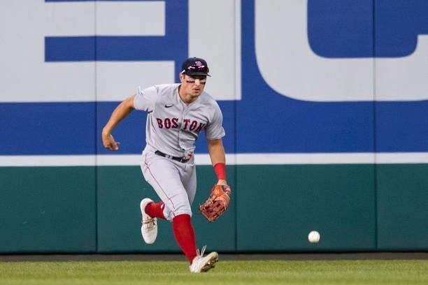 Hunter Renfroe of the Boston Red Sox reacts as he loses track of a fly ball in the lights during the eighth inning of a game against the Washington...