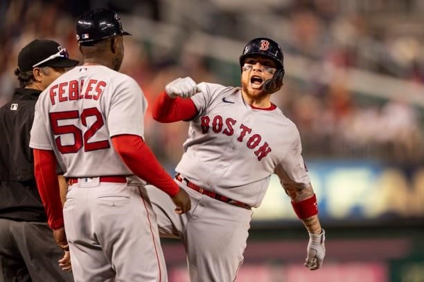 Christian Vazquez of the Boston Red Sox reacts after hitting a go-ahead RBI triple during the ninth inning of a game against the Washington Nationals...