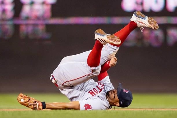 Xander Bogaerts of the Boston Red Sox reacts as he falls over after a play during the eighth inning of a game against the Washington Nationals on...