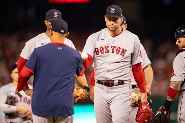 Adam Ottavino of the Boston Red Sox hands the ball to manager Alex Cora as he exits the game during the eighth inning of a game against the...