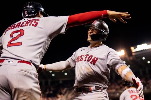 Enrique Hernandez of the Boston Red Sox reacts with Xander Bogaerts after hitting a two-run home run during the ninth inning of a game against the...