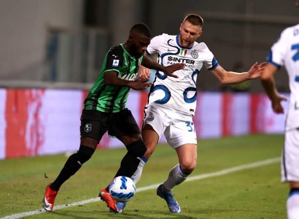 Jeremie Boga of US Sassuolo competes for the ball with Milan Skriniar of FC Internazionale ,during the Serie A match between US Sassuolo v FC...