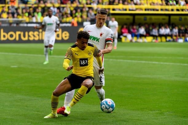 Jeffrey Gouweleeuw of FC Augsburg and Donyell Malen of Borussia Dortmund battle for the ball during the Bundesliga match between Borussia Dortmund...
