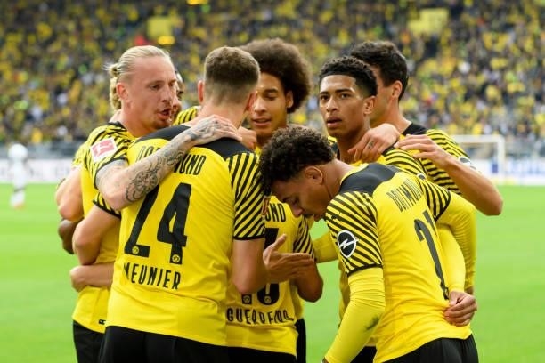 Raphael Guerreiro of Borussia Dortmund celebrates after scoring his team's first goal with teammates during the Bundesliga match between Borussia...