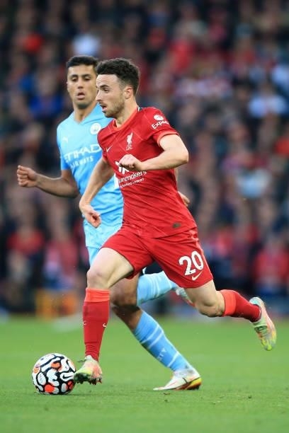 Diogo Jota of Liverpool battles with Rodri of Manchester City during the Premier League match between Liverpool and Manchester City at Anfield on...