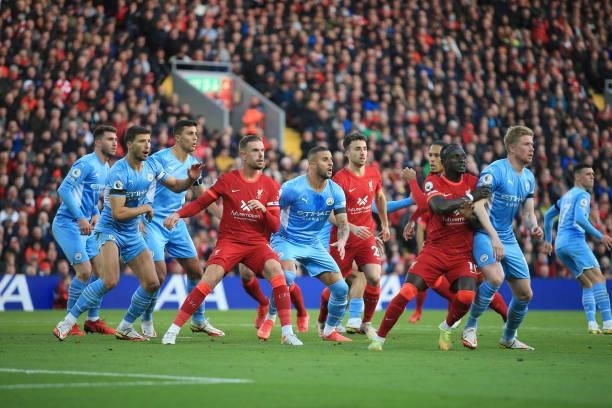 Players including Jordan Henderson of Liverpool and Kyle Walker of Manchester City tussle for position during the Premier League match between...