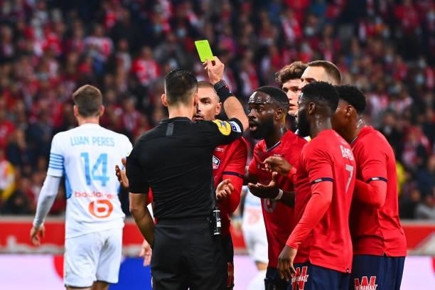 Burak YILMAZ of Lille receives a yellow card during the Ligue 1 Uber Eats match between Lille and Marseille at Stade Pierre Mauroy on October 3, 2021...
