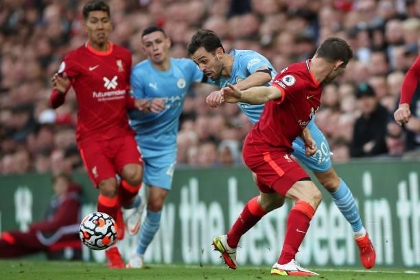 James Milner of Liverpool tackles Bernardo Silva of Manchester City during the Premier League match between Liverpool and Manchester City at Anfield...