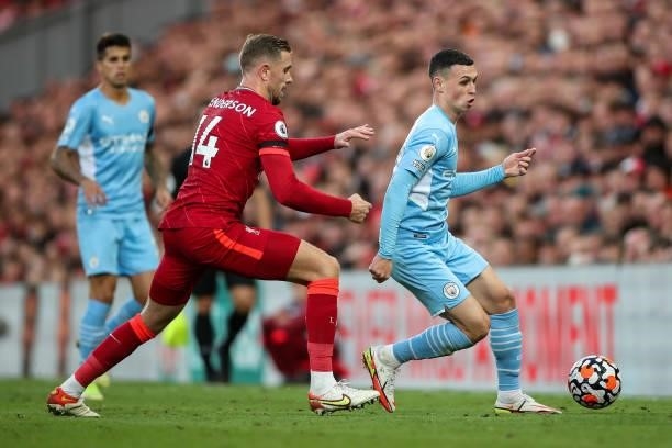 Jordan Henderson of Liverpool and Phil Foden of Manchester City during the Premier League match between Liverpool and Manchester City at Anfield on...