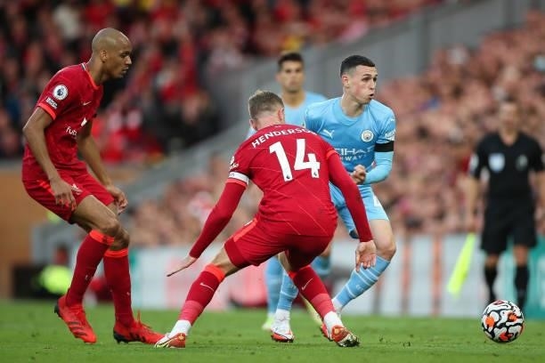 Jordan Henderson of Liverpool and Phil Foden of Manchester City during the Premier League match between Liverpool and Manchester City at Anfield on...