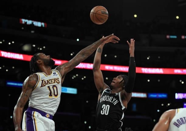 DeAndre Jordan of the Los Angeles Lakers block a shot by DeAndre Jordan#30 of the Brooklyn Nets during the first half of pre season game at Staples...