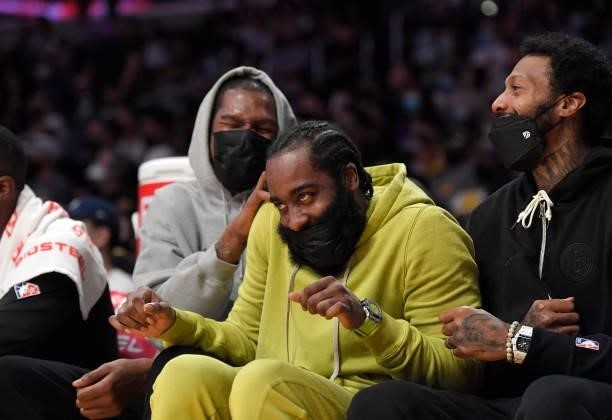 Kevin Durant Kyrie Irving and James Johnson of the Brooklyn Nets laugh on the bench get together during the first half of a pre season game against...