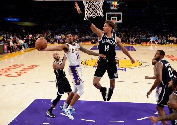 Malik Monk of the Los Angeles Lakers drives to the basket during the first half of a pre season game against Kessler Edwards of the Brooklyn Nets at...