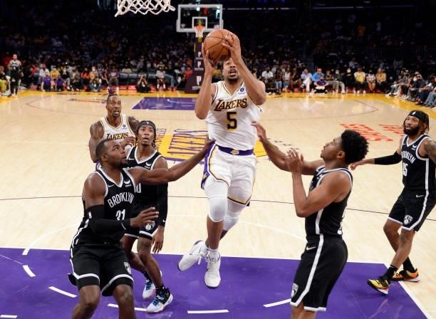 Talen Horton-Tucker of the Los Angeles Lakers drives to the basket during the first half of a pre season game against Paul Millsap of the Brooklyn...