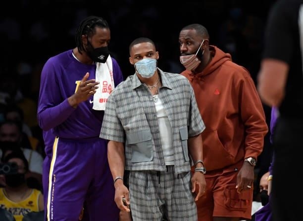 DeAndre Jordan, Russell Westbrook and LeBron James of the Los Angeles Lakers on the sideline during the second half of a pre son game against the...