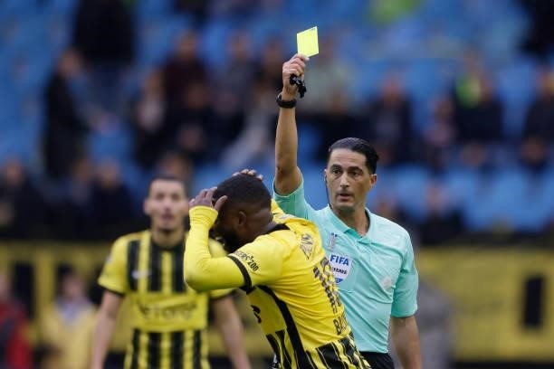 Referee Serdar Gozubuyuk gives a yellow card to Riechedly Bazoer of Vitesse during the Dutch Eredivisie match between Vitesse v Feyenoord at the...