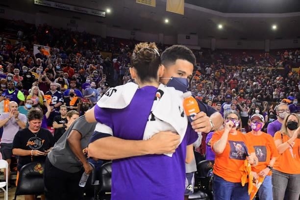 Devin Booker of the Phoenix Suns hugs Diana Taurasi of the Phoenix Mercury after the game against the Las Vegas Aces during Game Three of the 2021...