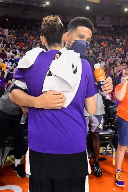 Devin Booker of the Phoenix Suns hugs Diana Taurasi of the Phoenix Mercury after the game against the Las Vegas Aces during Game Three of the 2021...