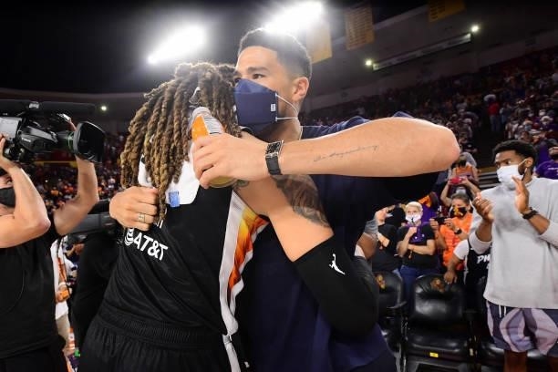Devin Booker of the Phoenix Suns hugs Brittney Griner of the Phoenix Mercury after the game against the Las Vegas Aces during Game Three of the 2021...