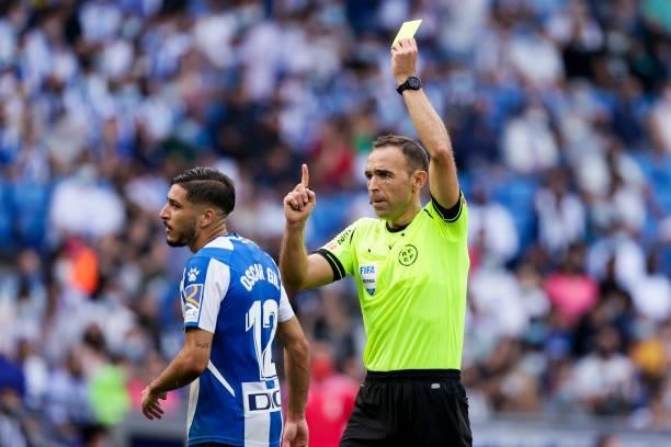 Referee Guillermo Cuadra Fernandez show the yellow card to Oscar Gil of VEspanyol during the La Liga Santander match between Espanyol v Real Madrid...