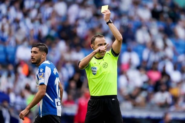 Referee Guillermo Cuadra Fernandez show the yellow card to Oscar Gil of VEspanyol during the La Liga Santander match between Espanyol v Real Madrid...