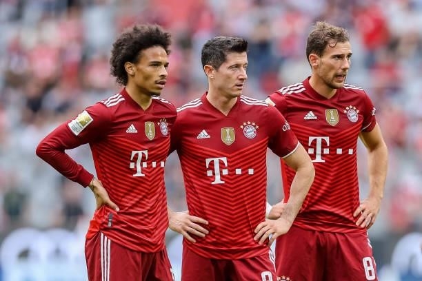 Leroy Sane of Bayern Muenchen, Robert Lewandowski of Bayern Muenchen and Leon Goretzka of Bayern Muenchen look on during the Bundesliga match between...