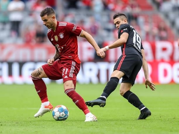 Lucas Hernandez of Bayern Muenchen and Rafael Borre of Eintracht Frankfurt battle for the ball during the Bundesliga match between FC Bayern Muenchen...