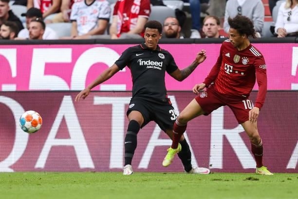 Tuta of Eintracht Frankfurt and Leroy Sane of Bayern Muenchen battle for the ball during the Bundesliga match between FC Bayern Muenchen and...