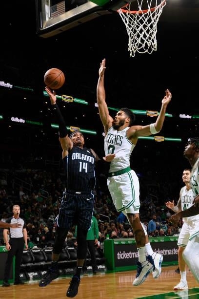 Jayson Tatum of the Boston Celtics plays defense on Gary Harris of the Orlando Magic during the game on October 4, 2021 at the TD Garden in Boston,...