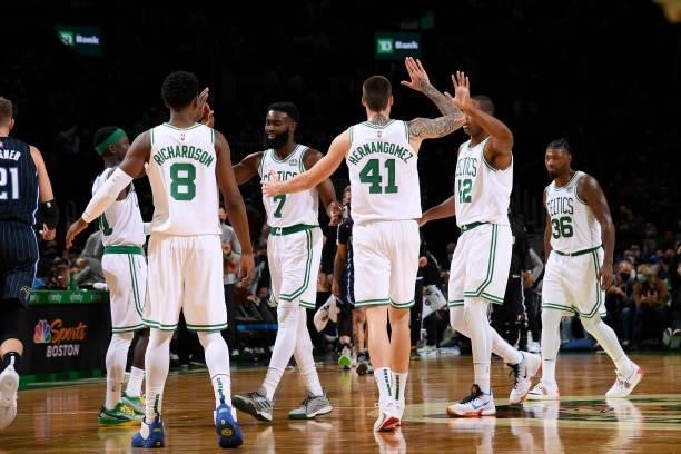 The Boston Celtics hi-five during the game against the Orlando Magic on October 4, 2021 at the TD Garden in Boston, Massachusetts. NOTE TO USER: User...