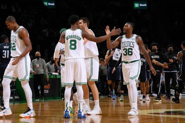 Marcus Smart hi-fives Josh Richardson of the Boston Celtics during the game against the Orlando Magic on October 4, 2021 at the TD Garden in Boston,...