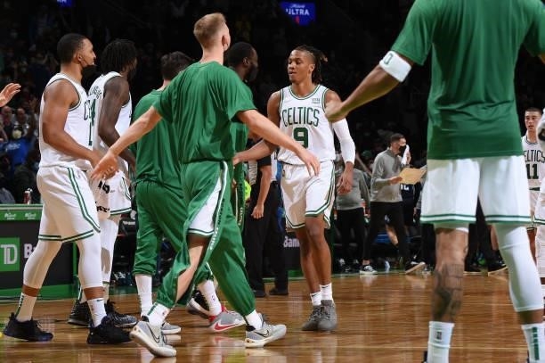 Romeo Langford of the Boston Celtics hi-fives teammates during the game against the Orlando Magic on October 4, 2021 at the TD Garden in Boston,...