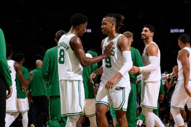 Josh Richardson hi-fives Romeo Langford of the Boston Celtics during the game against the Orlando Magic on October 4, 2021 at the TD Garden in...