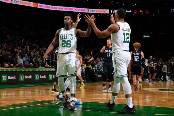 Aaron Nesmith hi-fives Grant Williams of the Boston Celtics during the game against the Orlando Magic on October 4, 2021 at the TD Garden in Boston,...