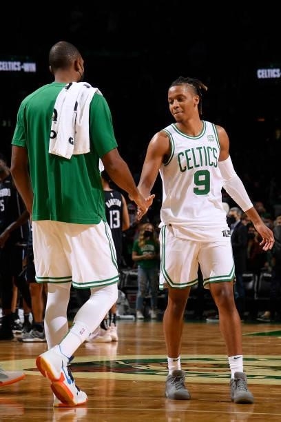 Romeo Langford hi-fives Al Horford of the Boston Celtics during the game against the Orlando Magic on October 4, 2021 at the TD Garden in Boston,...