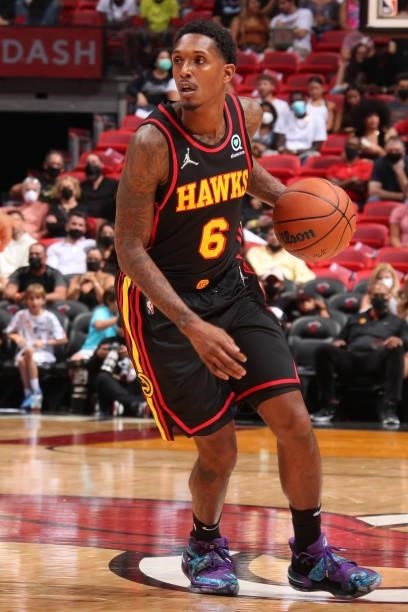 Lou Williams of the Atlanta Hawks dribbles the ball during a preseason game against the Miami Heat on October 4, 2021 at FTX Arena in Miami, Florida....