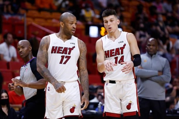 Tucker of the Miami Heat talks to teammate Tyler Herro during a preseason game against the Atlanta Hawks on October 4, 2021 at FTX Arena in Miami,...