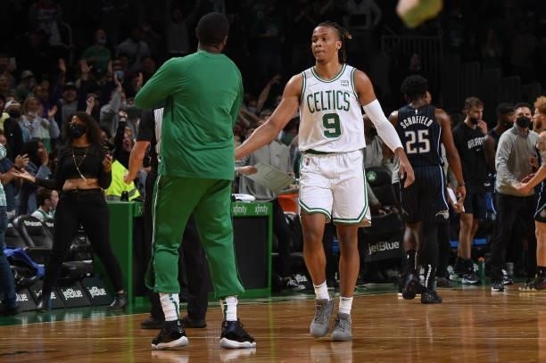 Romeo Langford of the Boston Celtics hi-fives teammates during the game against the Orlando Magic on October 4, 2021 at the TD Garden in Boston,...