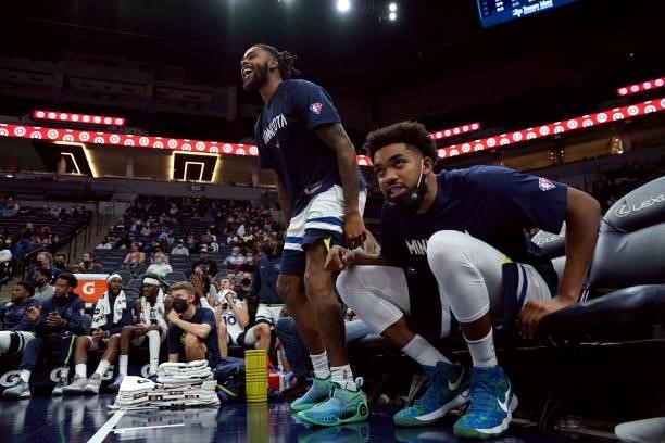 Angelo Russell and Karl-Anthony Towns of the Minnesota Timberwolves celebrate from the bench during a preseason game against the New Orleans Pelicans...