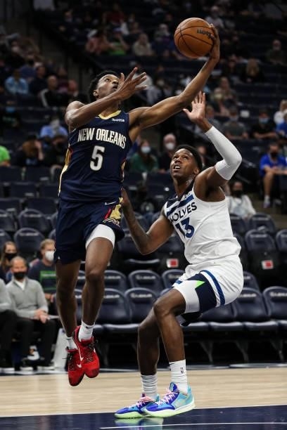 Herbert Jones of the New Orleans Pelicans goes up for a shot past Nathan Knight of the Minnesota Timberwolves in the fourth quarter of a preseason...