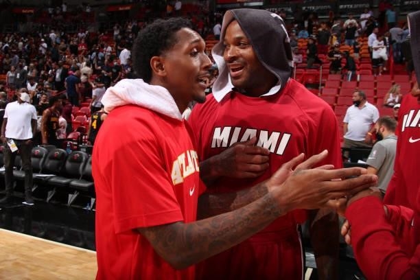 Tucker of the Miami Heat talks with Lou Williams of the Atlanta Hawks after a preseason game on October 4, 2021 at FTX Arena in Miami, Florida. NOTE...